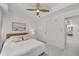 Bright bedroom with white walls and decor, art work, and view of the en-suite bath at 450 Knights Run Ave # 104, Tampa, FL 33602