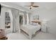 Bright bedroom with a ceiling fan, curtains and balcony access that offers natural light and fresh air at 450 Knights Run Ave # 104, Tampa, FL 33602