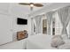 Cozy bedroom with a balcony view providing outdoor access and natural light, complemented with a TV at 450 Knights Run Ave # 104, Tampa, FL 33602