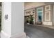 Inviting building entrance with 'The Plaza' signage, stylish planters, and a convenient seating area at 450 Knights Run Ave # 104, Tampa, FL 33602
