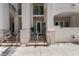 Inviting building entrance featuring bright stucco, steps, and minimalist hand railings leading to a glass door at 450 Knights Run Ave # 104, Tampa, FL 33602
