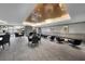 Well-lit common room with a piano, stylish seating, tables, and large windows offering serene views at 450 Knights Run Ave # 104, Tampa, FL 33602