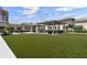 Inviting outdoor community space with shaded seating, barbecue grills, and a large manicured lawn for residents to enjoy at 450 Knights Run Ave # 104, Tampa, FL 33602