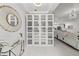 Stylish hallway features a unique mirror and glass enclosed cabinet doors for added storage and design at 450 Knights Run Ave # 104, Tampa, FL 33602