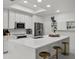 Modern kitchen with a spacious quartz island, stainless steel appliances, and stylish pendant lighting at 450 Knights Run Ave # 104, Tampa, FL 33602