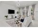 Bright, airy living room with modern furnishings, a large TV, and stylish decor at 450 Knights Run Ave # 104, Tampa, FL 33602