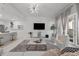 Bright living room with open floorplan, showcasing modern lighting and inviting seating arrangements at 450 Knights Run Ave # 104, Tampa, FL 33602