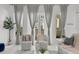 Bright living room featuring large windows with sheer curtains and two comfortable armchairs at 450 Knights Run Ave # 104, Tampa, FL 33602