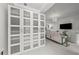 Stylish hallway featuring a unique display cabinet with glass doors, leading to living area at 450 Knights Run Ave # 104, Tampa, FL 33602