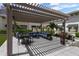 Comfortable seating area with a pergola, green turf, well-maintained landscaping and inviting ambiance at 450 Knights Run Ave # 104, Tampa, FL 33602