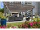 A peaceful lounge area featuring comfortable seating and colorful flowerbeds with a pergola and turf at 450 Knights Run Ave # 104, Tampa, FL 33602