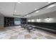 Relaxing lounge with comfortable seating, a large flatscreen TV and stylish built-in bookcases at 450 Knights Run Ave # 104, Tampa, FL 33602