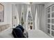 Bright main bedroom featuring balcony access with elegant curtains and neutral tones at 450 Knights Run Ave # 104, Tampa, FL 33602