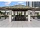 An outdoor kitchen featuring stone counters, a grill and seating, perfect for outdoor entertaining at 450 Knights Run Ave # 104, Tampa, FL 33602