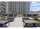 Beautiful outdoor patio featuring elegant tables, chairs and manicured landscaping at 450 Knights Run Ave # 104, Tampa, FL 33602