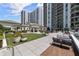 A spacious patio area with seating, grassy areas, and well-maintained landscaping creating an inviting atmosphere at 450 Knights Run Ave # 104, Tampa, FL 33602
