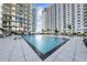 Large swimming pool surrounded by lush landscaping and high-rise buildings at 450 Knights Run Ave # 104, Tampa, FL 33602