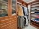 Large walk-in closet featuring custom storage solutions with wooden shelving, drawers, and hanging space at 450 Knights Run Ave # 104, Tampa, FL 33602