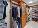 Spacious walk-in closet featuring custom built-in storage with drawers, shelving, and hanging racks at 450 Knights Run Ave # 104, Tampa, FL 33602