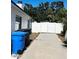 Backyard with concrete driveway and white fence at 4511 Hampshire Rd, Tampa, FL 33634