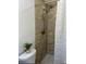 Bathroom featuring a shower with marbled tiles, golden fixtures and herringbone curtain at 4511 Hampshire Rd, Tampa, FL 33634