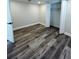 A bedroom with hardwood floors and a closet with folding doors at 4511 Hampshire Rd, Tampa, FL 33634