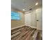 A bedroom with hardwood floors and a closet with folding doors and a window at 4511 Hampshire Rd, Tampa, FL 33634