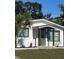 Charming home exterior featuring a well-manicured lawn and inviting curb appeal on a sunny day at 4511 Hampshire Rd, Tampa, FL 33634