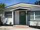 Inviting front door with a green painted finish and a charming, covered entryway at 4511 Hampshire Rd, Tampa, FL 33634