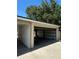 View of the detached garage with open garage door and tan trim on a sunny day at 4511 Hampshire Rd, Tampa, FL 33634