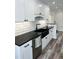 A kitchen with white cabinets, stainless steel appliances, and granite countertops at 4511 Hampshire Rd, Tampa, FL 33634