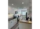 A kitchen with white cabinets, stainless steel appliances, and granite countertops at 4511 Hampshire Rd, Tampa, FL 33634