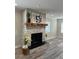 A living room with a stone fireplace and wooden mantel at 4511 Hampshire Rd, Tampa, FL 33634