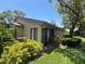 Exterior view of the home with lush greenery and a beautiful tree in the backyard at 4558 Morningside # 43, Sarasota, FL 34235