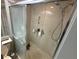 Bathroom featuring shower with sliding glass door and shower head with mounted towel rack and shelf at 4558 Morningside # 43, Sarasota, FL 34235