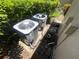 Image of the exterior HVAC units surrounded by lush greenery and attached to the property's wall at 4558 Morningside # 43, Sarasota, FL 34235