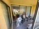 Enclosed patio with sliding glass doors, two chairs, a small table, and a clear view of the outdoors at 4558 Morningside # 43, Sarasota, FL 34235