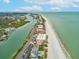 Scenic aerial view showcasing beachfront properties, canal, and Gulf of Mexico in Indian Rocks at 464 20Th Ave, Indian Rocks Beach, FL 33785
