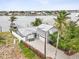Aerial view of a waterfront home with a backyard pool, lush landscaping, and private boat dock at 464 20Th Ave, Indian Rocks Beach, FL 33785