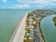 Stunning aerial view showcasing the coastline, waterfront buildings, and a nearby river at 464 20Th Ave, Indian Rocks Beach, FL 33785