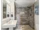 Bathroom with a glass shower, gray wood-look tile, and white honeycomb tile on the floor at 464 20Th Ave, Indian Rocks Beach, FL 33785