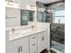 Modern bathroom showcasing a double vanity, large mirror, and a glass-enclosed shower with stylish tiling at 464 20Th Ave, Indian Rocks Beach, FL 33785