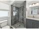 Modern bathroom features a gray-toned glass shower, sleek vanity, and elegant fixtures at 464 20Th Ave, Indian Rocks Beach, FL 33785