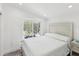 Bedroom with white-tone walls, wood laminate floor, and a large window that fills the room with natural light at 464 20Th Ave, Indian Rocks Beach, FL 33785