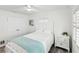 Cozy bedroom with white walls, modern fan, and ample natural light, showcasing a tranquil space at 464 20Th Ave, Indian Rocks Beach, FL 33785