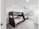 Bedroom features two bunk beds, wood-look floors, a ceiling fan and a window at 464 20Th Ave, Indian Rocks Beach, FL 33785