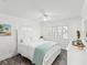 Bright bedroom featuring gray floors, white furnishings, and a cool-toned accent blanket at 464 20Th Ave, Indian Rocks Beach, FL 33785