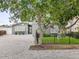 Charming gray home with a meticulously paved driveway, manicured lawn, and mature trees at 464 20Th Ave, Indian Rocks Beach, FL 33785