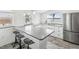 Modern kitchen with stainless steel appliances, sleek countertops, and a breakfast bar with seating at 464 20Th Ave, Indian Rocks Beach, FL 33785
