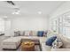 Spacious living room featuring a comfortable sectional sofa and wood-look flooring at 464 20Th Ave, Indian Rocks Beach, FL 33785